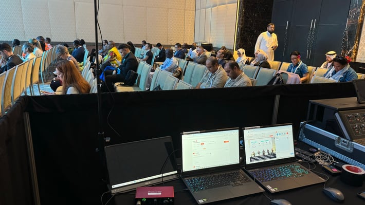 2 laptops in a room using Interprefy AI to support multilingual events