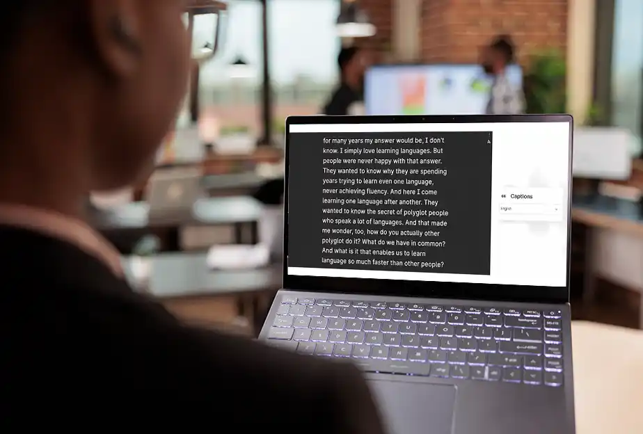 Interprefy - Healhcare - Live Captions - Man infront of laptop-1